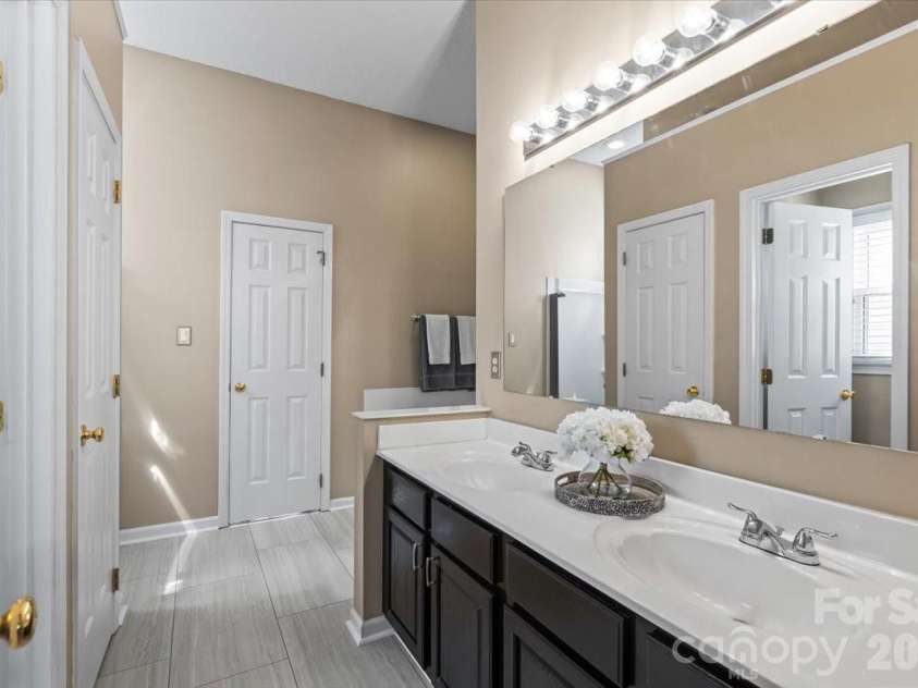 14413 John Beck Drive, Charlotte, NC 28273.  MLS# CAR4374623, YatesRealty ID 19941. 5-piece en suite featuring a garden tub, updated tile shower with frameless glass door, double vanity, a separate water closet and oversized walk-in closet