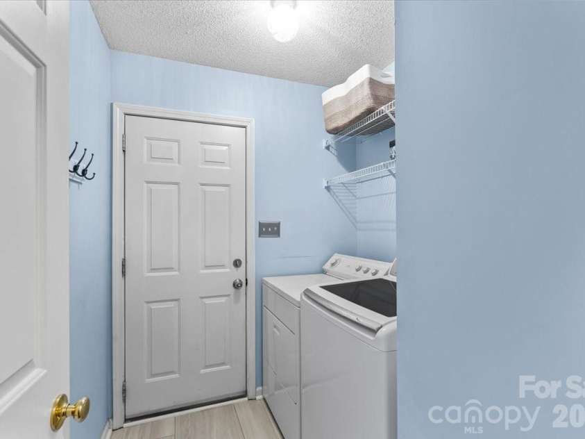 14413 John Beck Drive, Charlotte, NC 28273.  MLS# CAR4374623, YatesRealty ID 19941. Enter from the 2-car garage, through the laundry room, with  updated tile flooring ~2023 and quick access straight through to the kitchen