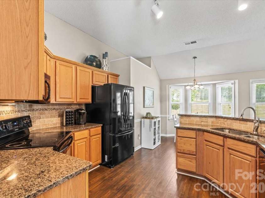 14413 John Beck Drive, Charlotte, NC 28273.  MLS# CAR4374623, YatesRealty ID 19941. Generous upper and lower cabinet storage and a pantry mean everyday cooking and prep stays easy and organized