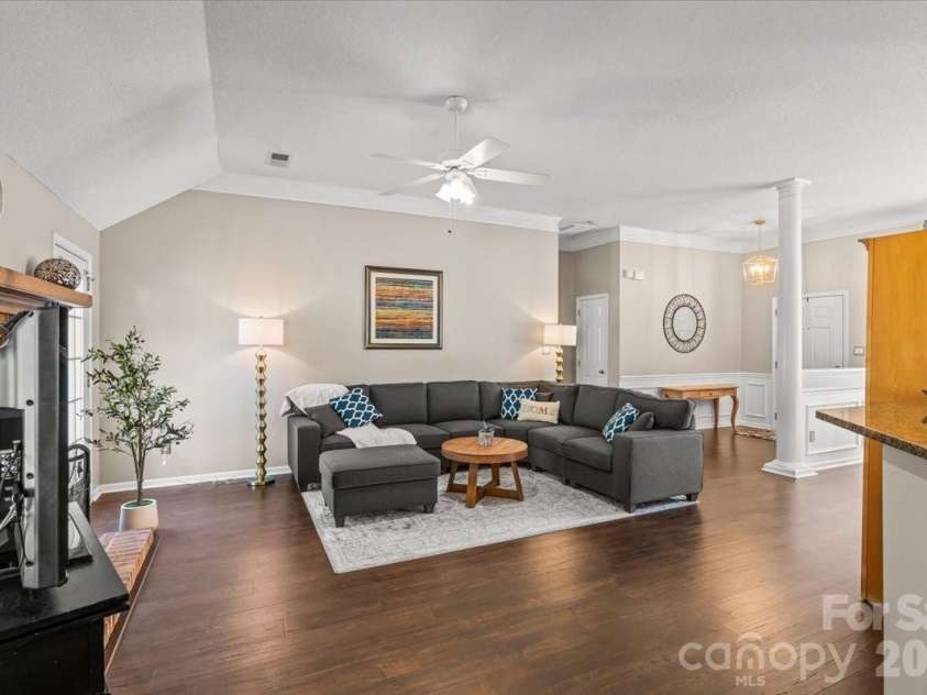 14413 John Beck Drive, Charlotte, NC 28273.  MLS# CAR4374623, YatesRealty ID 19941. Spacious living room with laminate wood flooring and a layout that lives well for everyday life and entertaining