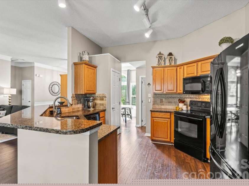 14413 John Beck Drive, Charlotte, NC 28273.  MLS# CAR4374623, YatesRealty ID 19941. Tile backsplash and a large dual-bowl stainless steel sink keep the kitchen both functional and beautiful