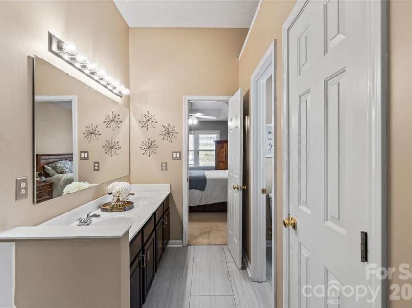 14413 John Beck Drive, Charlotte, NC 28273.  MLS# CAR4374623, YatesRealty ID 19941. Tile flooring ~2023 and a double vanity offer everyday function with a clean, refreshed look