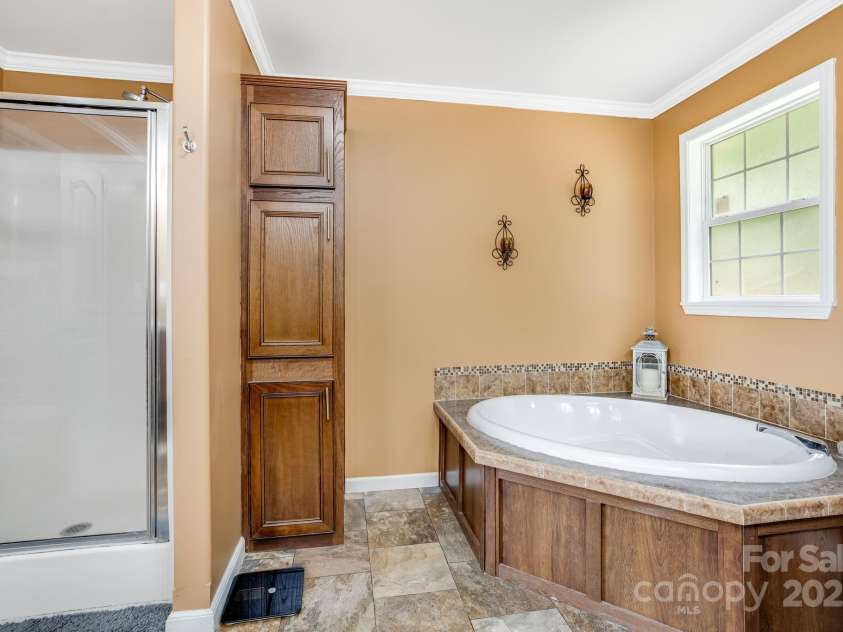 14 Phoenix Circle, Alexander, NC 28701.  MLS# CAR4255893, YatesRealty ID 19945. Master en-suite bathroom garden tub