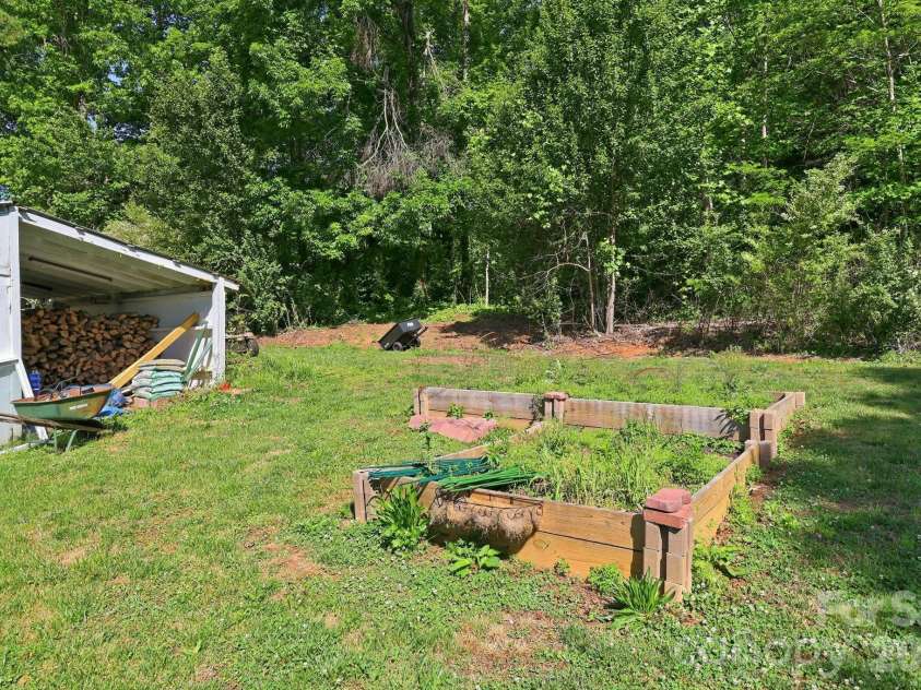 5054 Sugar Hill Road, Marion, NC 28752.  MLS# CAR4359799, YatesRealty ID 19956. Garden Planters in Back Yard