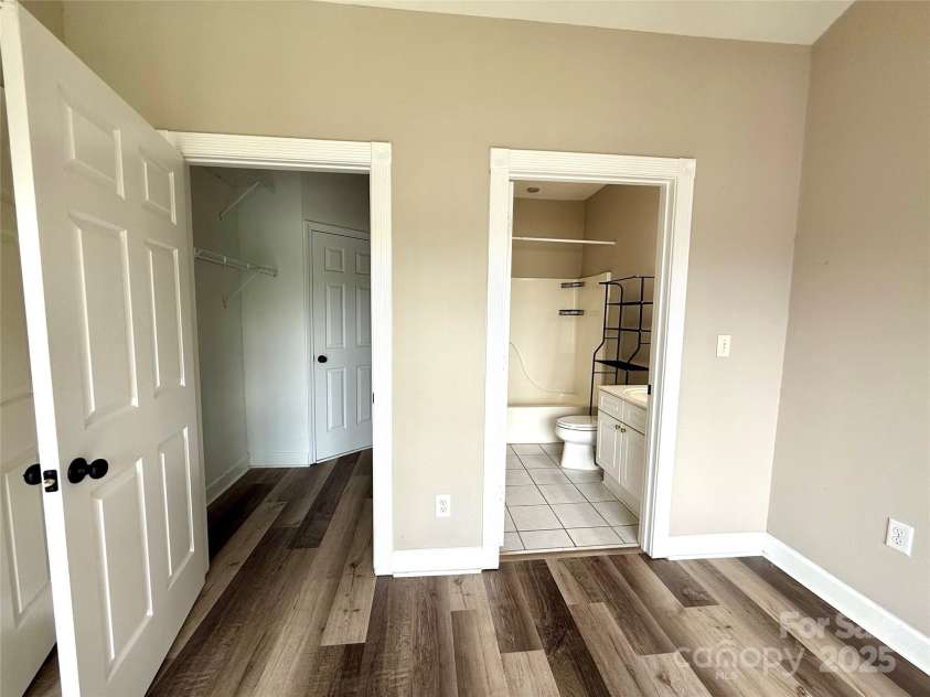 8668 Coralbell Lane, Charlotte, NC 28213.  MLS# CAR4225758, YatesRealty ID 19966. Large walk-in closet in primary bedroom.