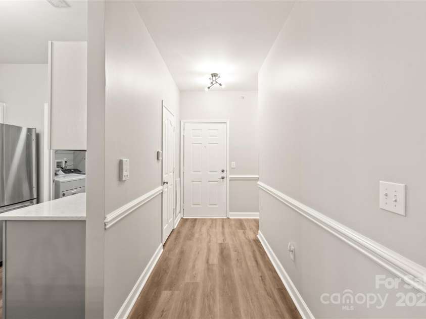 16344 Redstone Mountain Lane, Charlotte, NC 28277.  MLS# CAR4269073, YatesRealty ID 19967. Open hall has guest room and office when you enter and leads into living area.