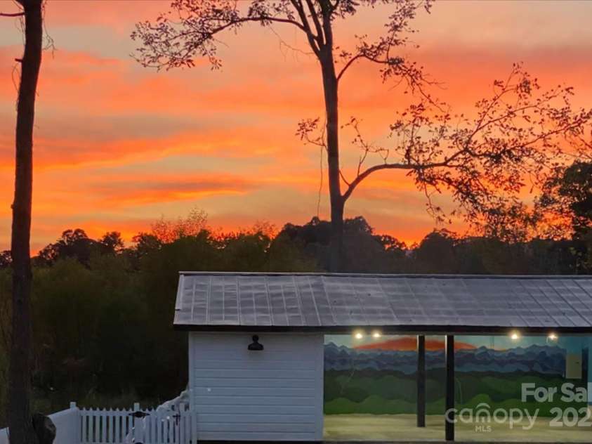 668 Old Hendersonville Highway, Brevard, NC 28712.  MLS# CAR4264741, YatesRealty ID 19974. Sunset over Workshop
