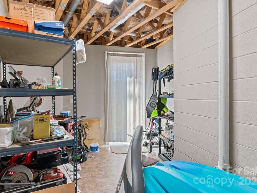 4948 Connestee Trail, Brevard, NC 28712.  MLS# CAR4231748, YatesRealty ID 1998. Lower level storage area or workshop