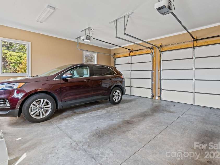 4948 Connestee Trail, Brevard, NC 28712.  MLS# CAR4231748, YatesRealty ID 1998. Short, easy driveway into a two car garage