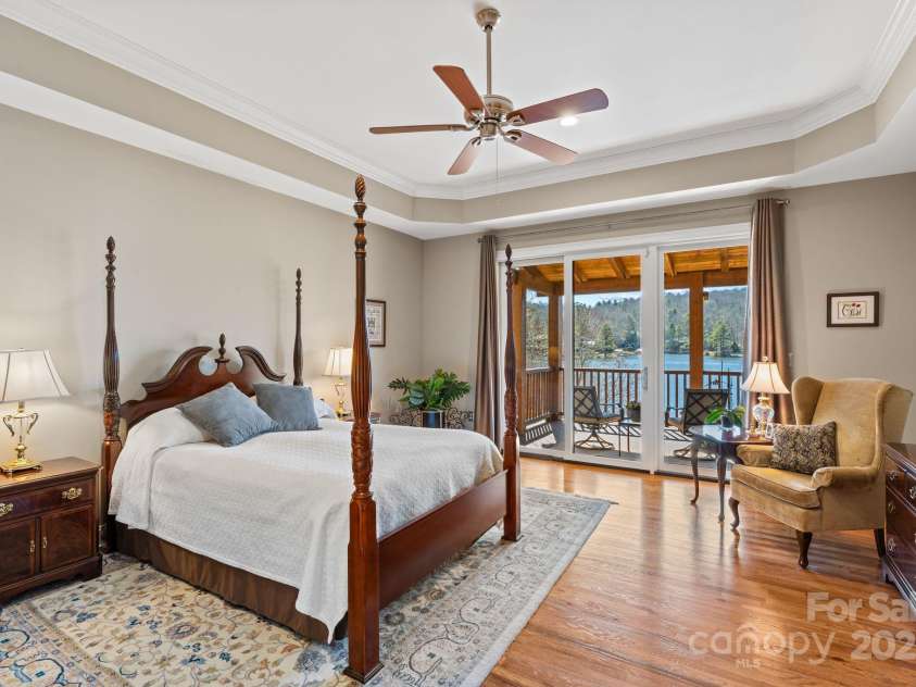 4948 Connestee Trail, Brevard, NC 28712.  MLS# CAR4231748, YatesRealty ID 1998. Spacious primary suite  on the main enjoys stunning lake views