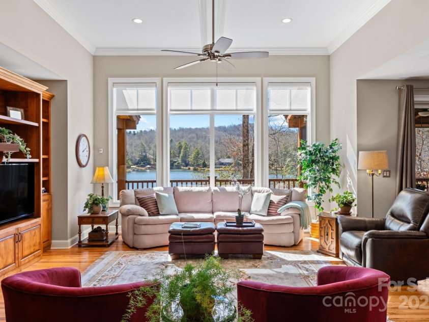 4948 Connestee Trail, Brevard, NC 28712.  MLS# CAR4231748, YatesRealty ID 1998. Wall of windows facing Lake Atagahi...