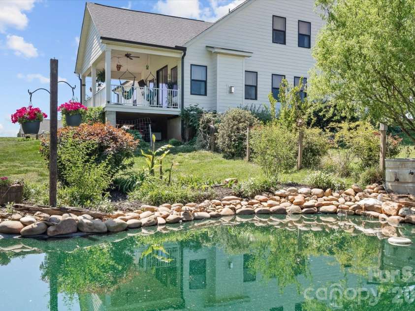 355 Cal Kennedy Road, Cleveland, NC 27013.  MLS# CAR4371840, YatesRealty ID 19980. Enjoy looking down over your custom water feature pond from the maintenance-free material covered back porch