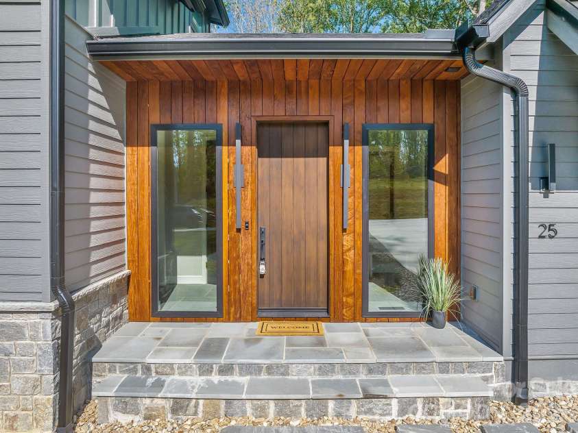 25 Ted Linn Drive, Fairview, NC 28730.  MLS# CAR4374836, YatesRealty ID 19987. Striking Ipe Brazilian Hardwood Entry Accent with Blue Stone Patio