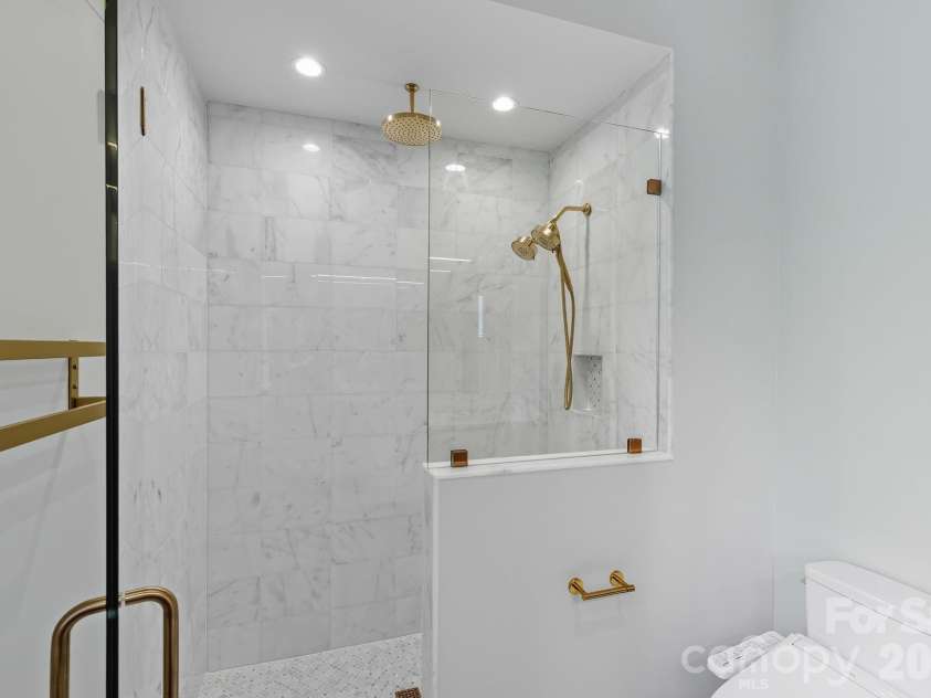 25 Ted Linn Drive, Fairview, NC 28730.  MLS# CAR4374836, YatesRealty ID 19987. Walk-in Shower with Custom Marble Tile and Rainhead Shower
