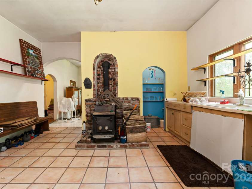 2347 Old Marshall Highway, Alexander, NC 28701.  MLS# CAR4176714, YatesRealty ID 1999. Unit 1 Wood Stove in Kitchen