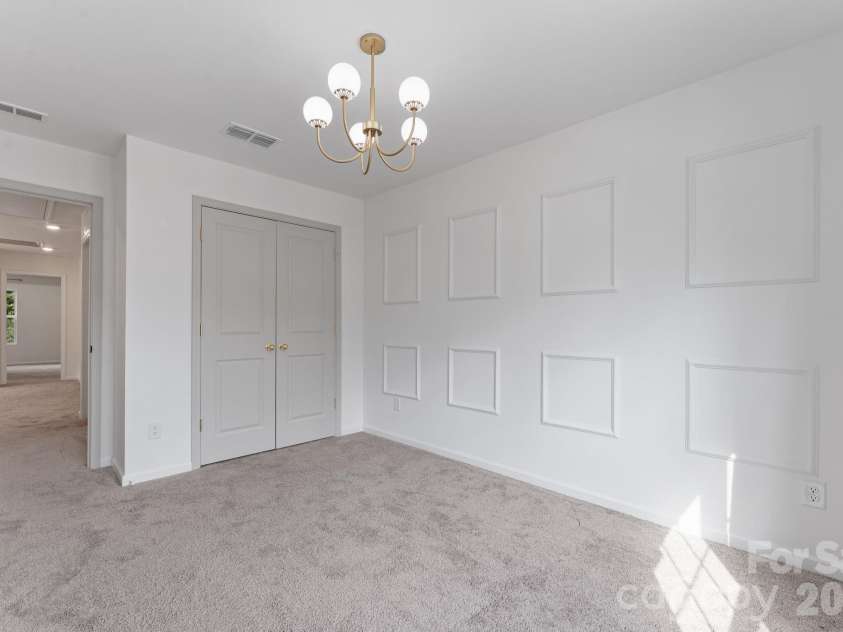 230 Quinn Road, Matthews, NC 28104.  MLS# CAR4378712, YatesRealty ID 19995. Feature wall and upgraded lighting