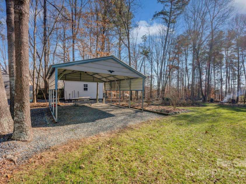 161 Picwyck Drive, Mooresville, NC 28115.  MLS# CAR4211316, YatesRealty ID 20000. Secondary earth driveway off cul-de-sac leads to carport