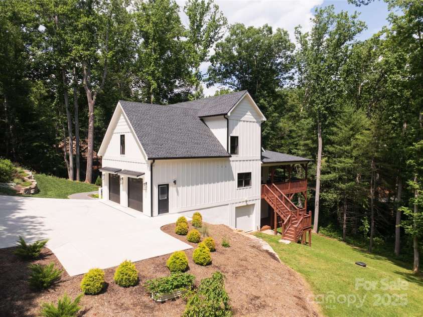 13 Cambridge Drive, Candler, NC 28715.  MLS# CAR4249606, YatesRealty ID 20021. Double garage on main with utility garage on lower level