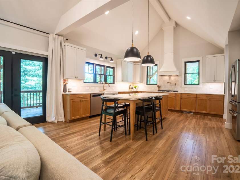 13 Cambridge Drive, Candler, NC 28715.  MLS# CAR4249606, YatesRealty ID 20021. Soaring vaulted ceilings, exposed wood beams