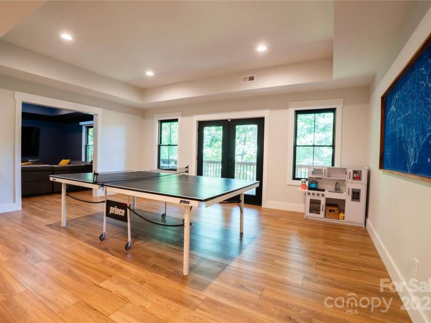13 Cambridge Drive, Candler, NC 28715.  MLS# CAR4249606, YatesRealty ID 20021. Spacious recreation room with deck access in basement