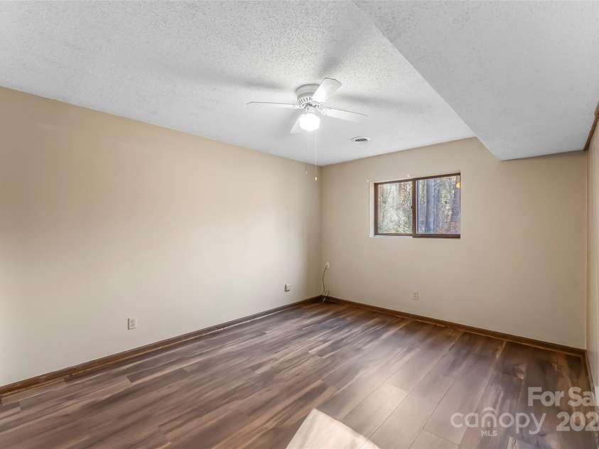 39 Oak Court, Fletcher, NC 28732.  MLS# CAR4330927, YatesRealty ID 20027. 3rd bedroom in basement updated flooring. 