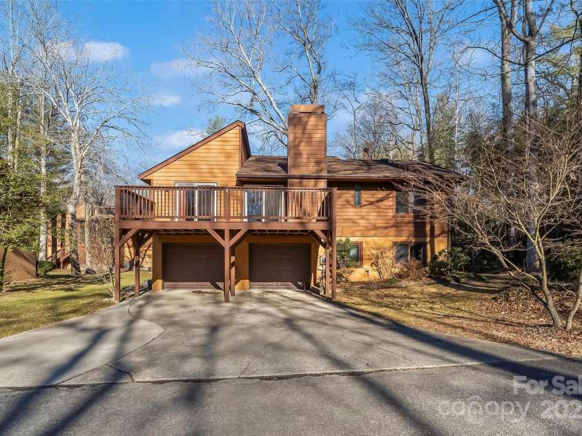 39 Oak Court, Fletcher, NC 28732.  MLS# CAR4330927, YatesRealty ID 20027. Deck was extended to add more outdoor space and also provides some driveway coverage. 