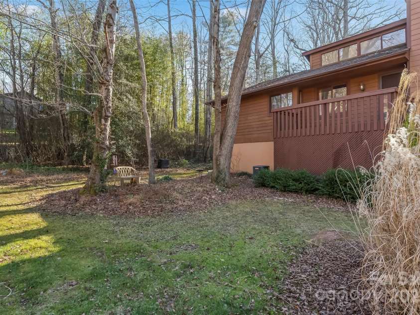 39 Oak Court, Fletcher, NC 28732.  MLS# CAR4330927, YatesRealty ID 20027. Front yard with outdoor sitting area. What a great place to reflect and enjoy the tranquil surroundings!