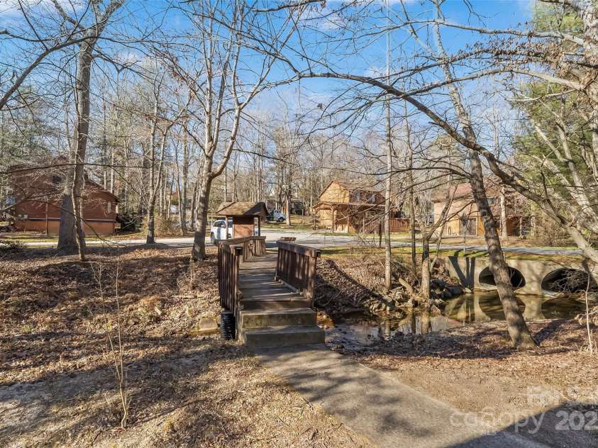 39 Oak Court, Fletcher, NC 28732.  MLS# CAR4330927, YatesRealty ID 20027. Nearby creek with bridge adds a picturesque view from the home.