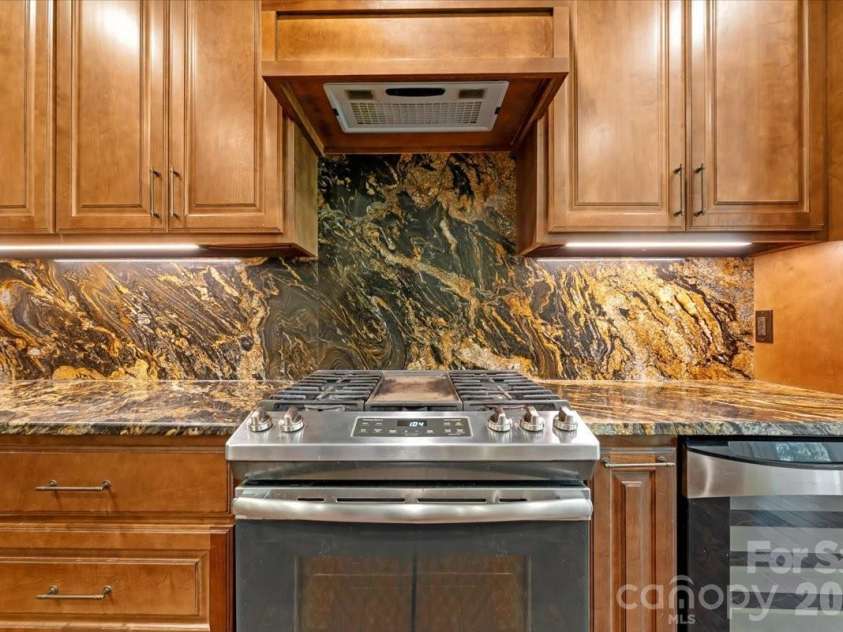 7304 Sedgebrook Drive, Stanley, NC 28164.  MLS# CAR4372754, YatesRealty ID 20028. Cook with intention. Entertain with ease. The gas range and built-in wine refrigerator make both effortless.