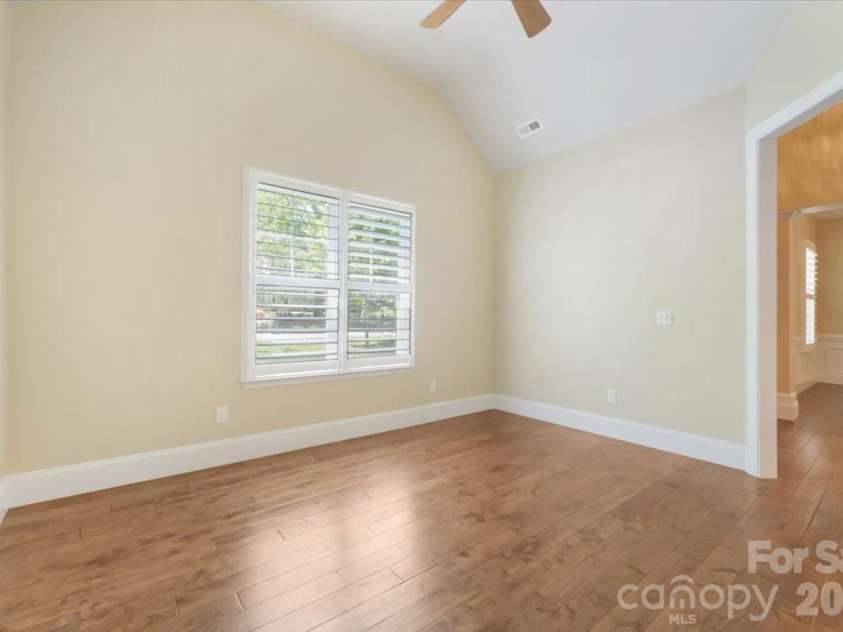 7304 Sedgebrook Drive, Stanley, NC 28164.  MLS# CAR4372754, YatesRealty ID 20028. Just off the foyer, the office/flex room makes a statement of its own — vaulted ceilings, plantation shutters, and engineered hardwoods turn a functional space into one you will actually want to spend time in.