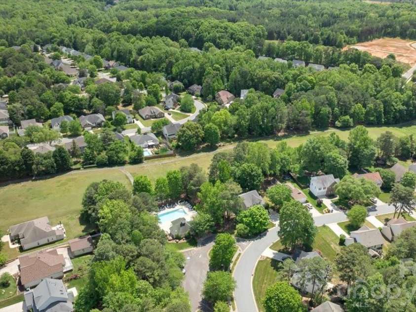 7304 Sedgebrook Drive, Stanley, NC 28164.  MLS# CAR4372754, YatesRealty ID 20028. The aerial view says it best — the community pool is just steps away, making summer at The Gates feel like a resort experience right outside your door.