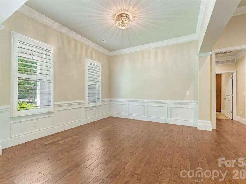 7304 Sedgebrook Drive, Stanley, NC 28164.  MLS# CAR4372754, YatesRealty ID 20028. The open dining room balances natural light, engineered hardwoods, and an upgraded light fixture in a way that makes every meal feel like an occasion.