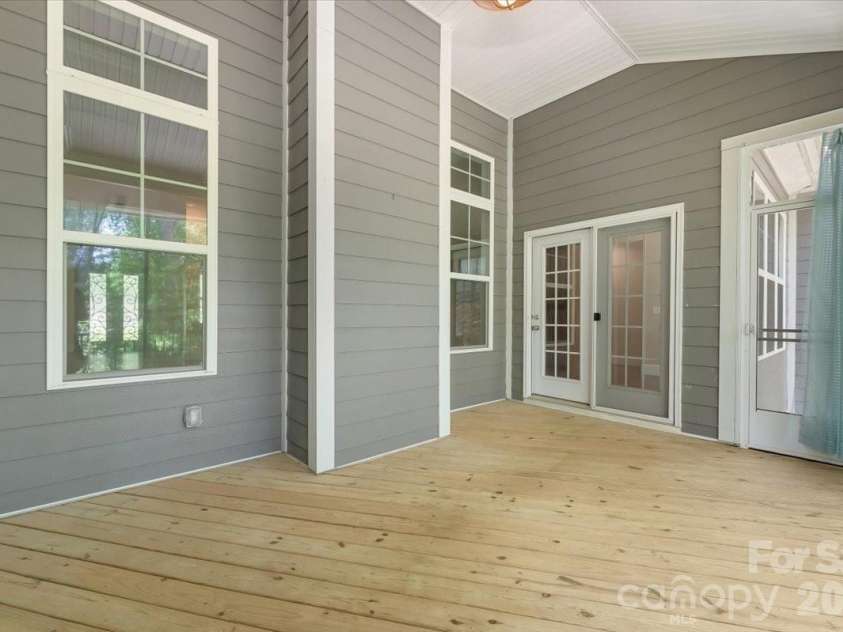 7304 Sedgebrook Drive, Stanley, NC 28164.  MLS# CAR4372754, YatesRealty ID 20028. The vaulted ceiling in the screened-in porch changes everything — suddenly this is not just a porch, it is an outdoor living room that breathes, opens up, and invites you to stay far longer than you planned.