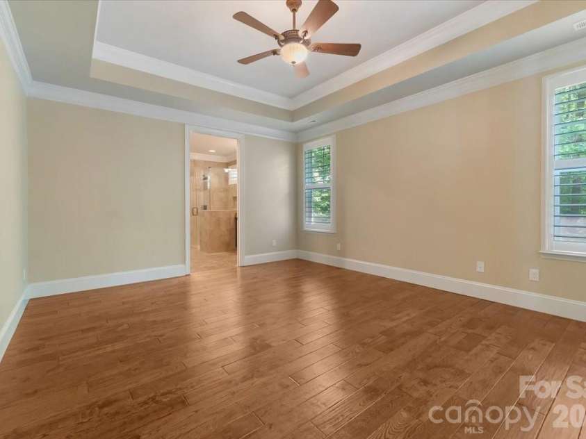 7304 Sedgebrook Drive, Stanley, NC 28164.  MLS# CAR4372754, YatesRealty ID 20028. Tray ceiling detail, engineered hardwoods, plantation shutters — and a view that is yours alone. No neighbors. Just nature.