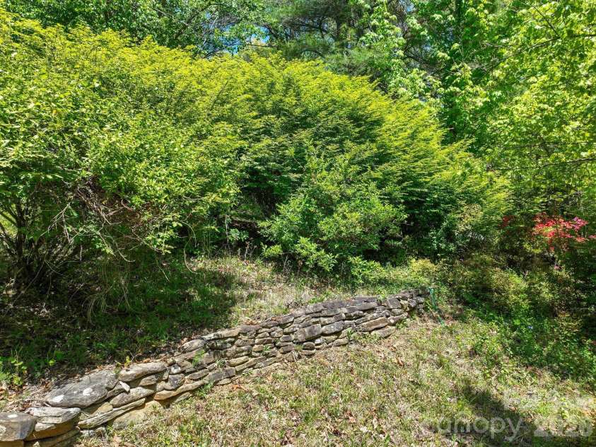 75 High Valley Estates Drive, Alexander, NC 28701.  MLS# CAR4372479, YatesRealty ID 20036. Beautiful old rock wall