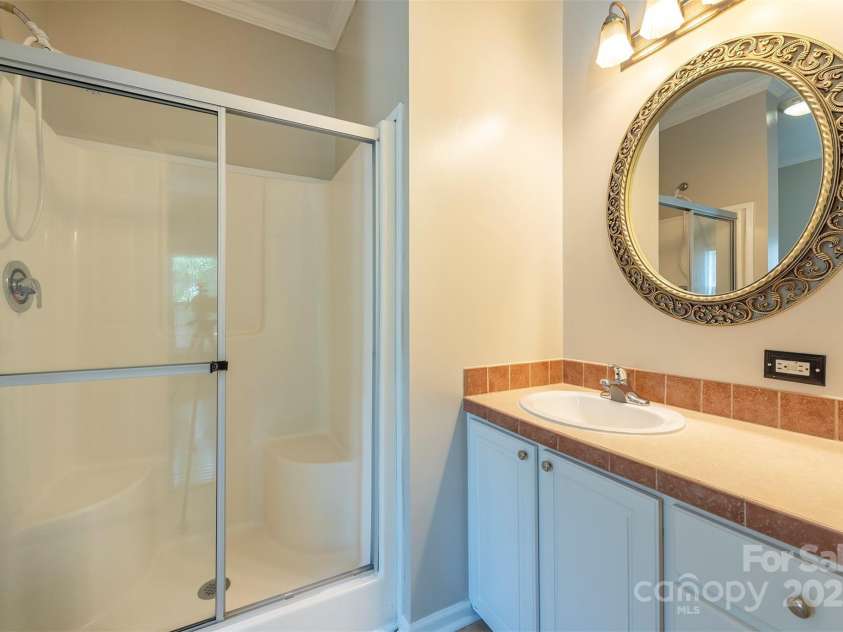 9 Everwood Drive, Candler, NC 28715.  MLS# CAR4269275, YatesRealty ID 20048. Primary bathroom with freshly painted cabinets