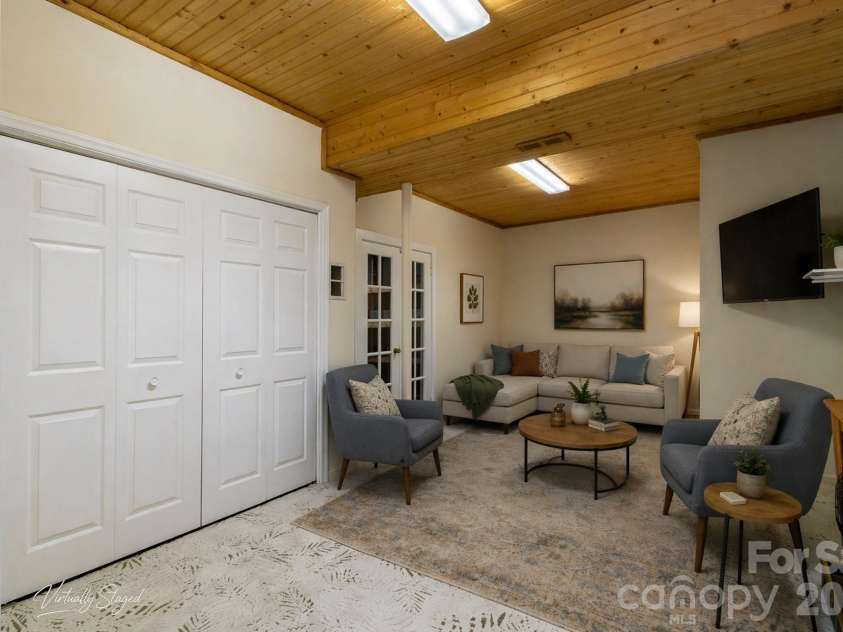 304 Emerald Hills Drive, Pisgah Forest, NC 28768.  MLS# CAR4373958, YatesRealty ID 20076. Basement bonus room/office features storage closets and access to the garage.virtually staged
