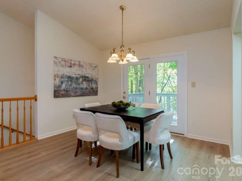 304 Emerald Hills Drive, Pisgah Forest, NC 28768.  MLS# CAR4373958, YatesRealty ID 20076. Dining Area – Dedicated dining area with updated lighting and direct access to the rear deck through glass doors. A bright and welcoming space for casual meals or formal gatherings.