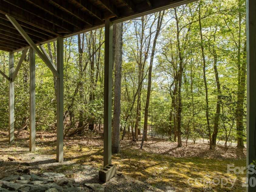 304 Emerald Hills Drive, Pisgah Forest, NC 28768.  MLS# CAR4373958, YatesRealty ID 20076. Lower Level Walkway – Functional lower-level entry with a covered walkway, providing convenient access and protection from the elements.