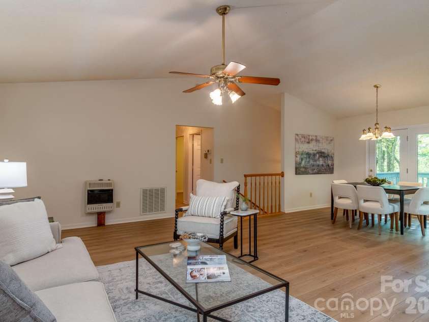 304 Emerald Hills Drive, Pisgah Forest, NC 28768.  MLS# CAR4373958, YatesRealty ID 20076. Open Living & Dining Space – Expansive open living and dining area with vaulted ceilings and seamless connectivity between spaces. Ideal for hosting guests or enjoying relaxed day-to-day living.
