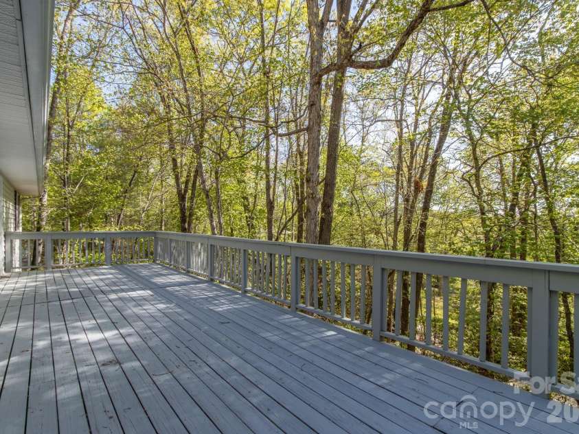 304 Emerald Hills Drive, Pisgah Forest, NC 28768.  MLS# CAR4373958, YatesRealty ID 20076. Rear Deck – Expansive rear deck provides ample space for outdoor seating and entertaining, overlooking a peaceful wooded backdrop.
