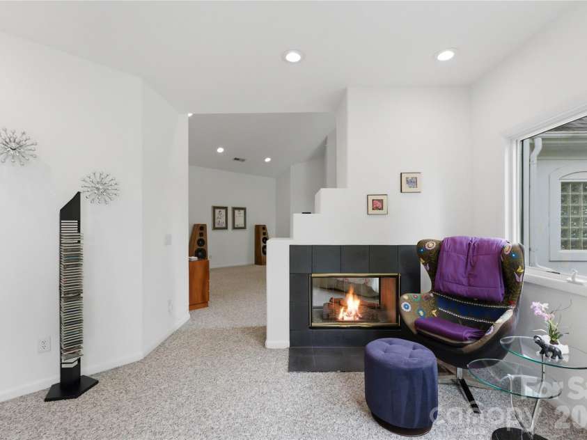 18426 Peninsula Cove Lane, Cornelius, NC 28031.  MLS# CAR4375387, YatesRealty ID 20078. Primary suite sitting area with fireplace