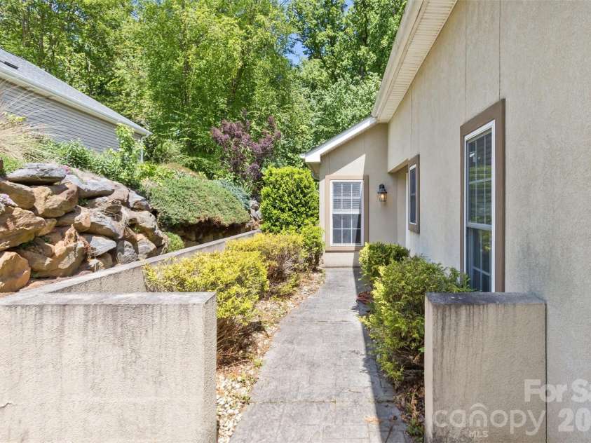 55 Stonebridge Drive, Asheville, NC 28805.  MLS# CAR4379940, YatesRealty ID 20084. Level yard, well maintained.