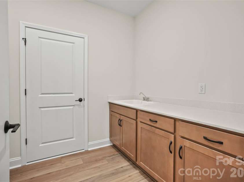 2720 Peak Court, Belmont, NC 28012.  MLS# CAR4331686, YatesRealty ID 20087. Spacious laundry room off the garage, featuring substantial storage and a utility sink