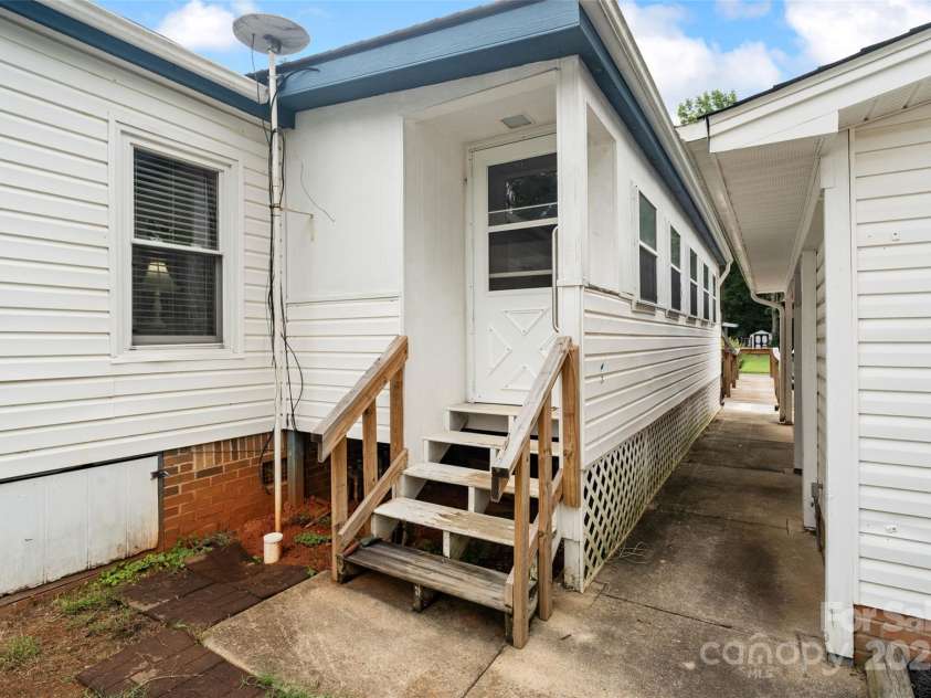 5909 Lake Valley Road, Clover, SC 29710.  MLS# CAR4288971, YatesRealty ID 2009. Area between enclosed porch and carport
