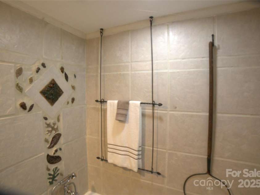 26 Kitazuma Road, Black Mountain, NC 28711.  MLS# CAR4199228, YatesRealty ID 20115. Bathroom on Main Level showing detail of tile and unique accents.