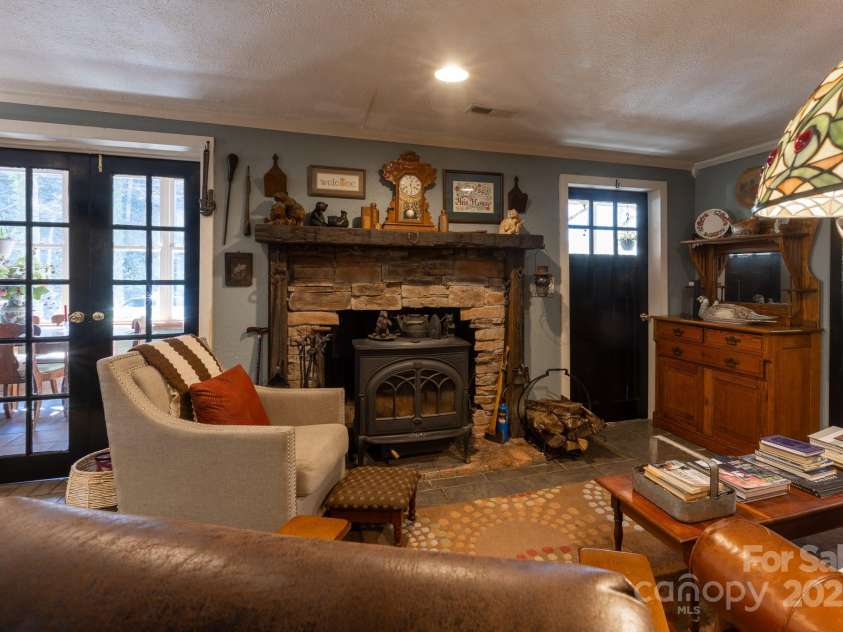 26 Kitazuma Road, Black Mountain, NC 28711.  MLS# CAR4199228, YatesRealty ID 20115. Cozy living room with a Jontul Stove.