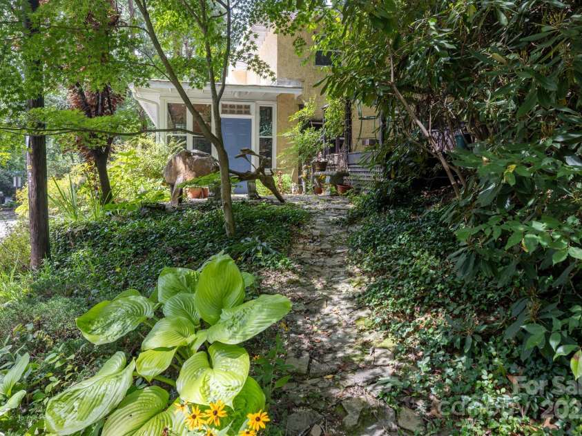 26 Kitazuma Road, Black Mountain, NC 28711.  MLS# CAR4199228, YatesRealty ID 20115. Side Garden and Door - no steps with this stone walkway!