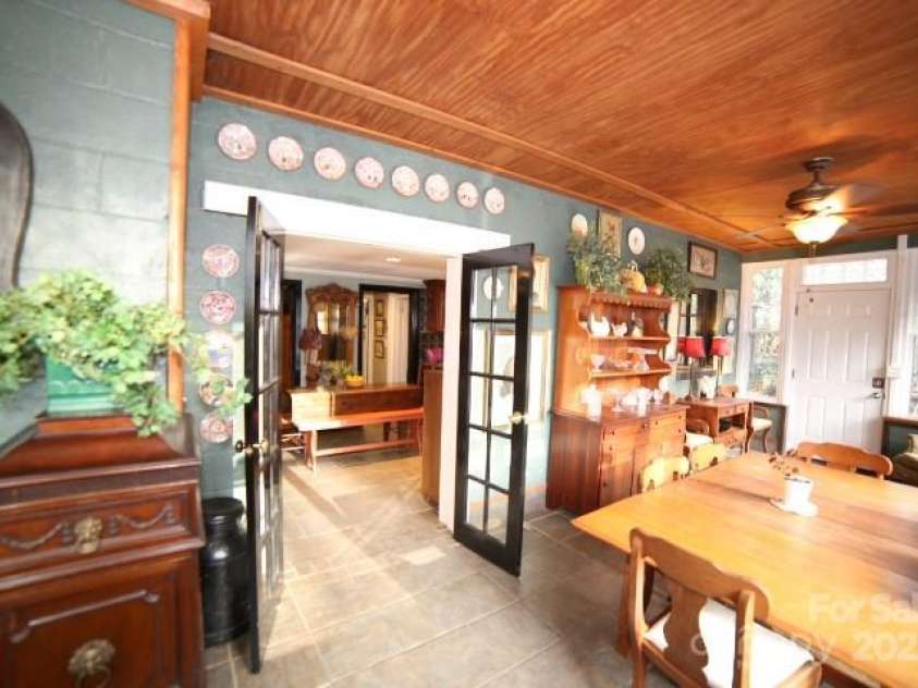 26 Kitazuma Road, Black Mountain, NC 28711.  MLS# CAR4199228, YatesRealty ID 20115. Sun porch with French Doors opening to interior of home.