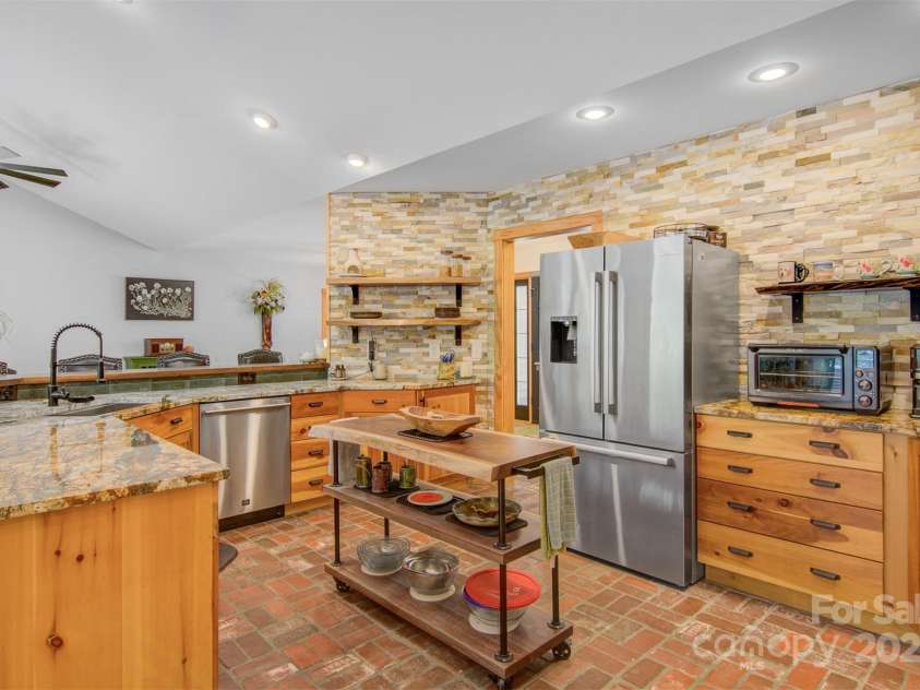 5690 Anchor Drive, Granite Falls, NC 28630.  MLS# CAR4252807, YatesRealty ID 20124. Unique brick floors, new granite counters and Black Walnut custom countertop on breakfast bar.